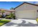Charming home featuring a well-maintained front lawn, manicured shrubs and a two-car garage at 11007 Batello Dr, Venice, FL 34292