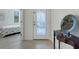 Elegant foyer with decorative glass door, tile flooring, and stylish console table at 11007 Batello Dr, Venice, FL 34292