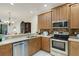 Well-appointed kitchen with stainless steel appliances, and adjacent dining and living areas at 11007 Batello Dr, Venice, FL 34292