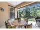 Enclosed lanai with comfortable seating and views of the lush, private backyard at 11007 Batello Dr, Venice, FL 34292