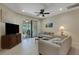 Inviting living room with comfortable seating, a ceiling fan, and sliding glass doors leading to the outdoors at 11007 Batello Dr, Venice, FL 34292