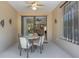 Cozy screened patio featuring outdoor seating and a ceiling fan, ideal for relaxing at 11007 Batello Dr, Venice, FL 34292