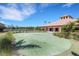 Well-maintained putting green offers a recreational space near the clubhouse and a tranquil pond at 11007 Batello Dr, Venice, FL 34292