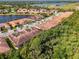 Scenic aerial view of residential community with pond, highlighting lush landscape and proximity to amenities at 11096 Campazzo Dr, Venice, FL 34292