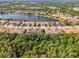 Expansive aerial view of community homes with a large lake, showcasing the neighborhood's setting at 11096 Campazzo Dr, Venice, FL 34292