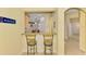 The open bar offers a view to the living and dining area at 11096 Campazzo Dr, Venice, FL 34292