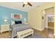 Bedroom features wood floors, neutral paint, ceiling fan, and access to an ensuite bathroom at 11096 Campazzo Dr, Venice, FL 34292