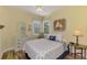 Nautical-themed bedroom with hardwood floors, a white dresser, and a twin bed with decorative pillows at 11096 Campazzo Dr, Venice, FL 34292