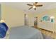 Bedroom features wood floors, neutral paint, ceiling fan, and plenty of natural light at 11096 Campazzo Dr, Venice, FL 34292