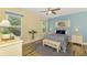 Bright bedroom boasts a large window, wood floors, and comfortable furnishings for a relaxing retreat at 11096 Campazzo Dr, Venice, FL 34292