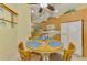 Bright breakfast nook featuring a round wooden table, seating for four, and natural lighting at 11096 Campazzo Dr, Venice, FL 34292