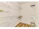 Walk-in closet has built-in shelving and wooden floors, providing ample space for clothes and storage at 11096 Campazzo Dr, Venice, FL 34292