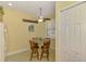 Bright dining area features a ceiling fan and shuttered windows at 11096 Campazzo Dr, Venice, FL 34292