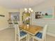 Inviting dining area showing an elegant chandelier and access to other living spaces at 11096 Campazzo Dr, Venice, FL 34292