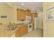 Kitchen features granite countertops, oak cabinets, and stainless appliances at 11096 Campazzo Dr, Venice, FL 34292