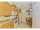 Eat-in kitchen features granite counters, oak cabinets, and stainless appliances at 11096 Campazzo Dr, Venice, FL 34292