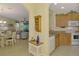 Eat-in kitchen features an archway view into the living room and dining area at 11096 Campazzo Dr, Venice, FL 34292