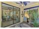 Screened-in lanai features outdoor seating, large windows, and a view of the beautifully landscaped backyard at 11096 Campazzo Dr, Venice, FL 34292