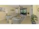 Comfortable living room with lots of seating, a view to the lanai, and stylish coastal decor at 11096 Campazzo Dr, Venice, FL 34292