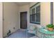 A cozy front patio area with outdoor seating and decor that gives the home a welcoming feel at 11096 Campazzo Dr, Venice, FL 34292
