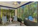 Relaxing sunroom with brick floors and outdoor views, offering a bright and airy space at 11096 Campazzo Dr, Venice, FL 34292