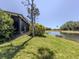 Scenic backyard view featuring lush lawn and a tranquil pond, offering serene waterfront living at 11924 Tempest Harbor Loop, Venice, FL 34292