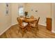 Dining room featuring wood floors, round table, and natural light at 11924 Tempest Harbor Loop, Venice, FL 34292