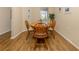 Charming dining area with wood floors, featuring a round table and a window at 11924 Tempest Harbor Loop, Venice, FL 34292