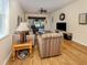 Cozy living room with wood floors, comfortable seating, and views of the outdoors at 11924 Tempest Harbor Loop, Venice, FL 34292