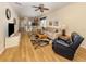 Open-concept living room with laminate floors, comfortable seating, and ample natural light at 11924 Tempest Harbor Loop, Venice, FL 34292