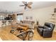 Open-concept living room featuring wood floors, neutral furniture, and bar seating at 11924 Tempest Harbor Loop, Venice, FL 34292