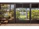 This relaxing screened-in lanai overlooks a serene lake with lush landscaping at 11924 Tempest Harbor Loop, Venice, FL 34292