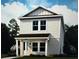 Charming two-story home featuring neutral siding, a covered entry, and verdant landscaping at 145 Thorne Ln, Sarasota, FL 34240