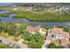 Beautiful aerial view of waterfront homes with mature trees and dock on a sunny day at 1500 Lemon Bay Dr, Venice, FL 34293