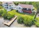 Back of home featuring a dock with kayak, large yard, and deck, perfect for outdoor living at 1500 Lemon Bay Dr, Venice, FL 34293
