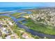 Scenic aerial shot of homes along the water with lush mangroves and the ocean in the distance at 1500 Lemon Bay Dr, Venice, FL 34293