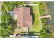 Birds eye view of home with expansive roof, lush greenery, and private dock at 1500 Lemon Bay Dr, Venice, FL 34293