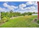 Large, fenced backyard, perfect for outdoor activities with mature trees and plenty of open space at 1500 Lemon Bay Dr, Venice, FL 34293