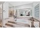 Modern bathroom boasts a large soaking tub, glass block window, and a separate tiled shower stall at 1500 Lemon Bay Dr, Venice, FL 34293