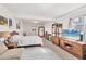 Spacious bedroom with television, carpet, and comfortable furnishings at 1500 Lemon Bay Dr, Venice, FL 34293