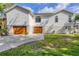 Inviting home featuring a three-car garage, manicured lawn, and charming curb appeal at 1500 Lemon Bay Dr, Venice, FL 34293
