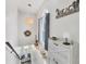 Bright hallway with stylish decor, natural light, and a cozy seating area at 1500 Lemon Bay Dr, Venice, FL 34293