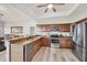 Spacious kitchen with granite countertops, wood cabinets, and stainless steel appliances at 1500 Lemon Bay Dr, Venice, FL 34293