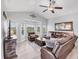Bright living room with a leather sectional, ceiling fan and views of the water at 1500 Lemon Bay Dr, Venice, FL 34293