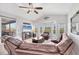Bright living room with vaulted ceilings, plush seating, and scenic views from large windows at 1500 Lemon Bay Dr, Venice, FL 34293