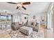 Comfortable living room with a fireplace and open floor plan to the dining area at 1500 Lemon Bay Dr, Venice, FL 34293