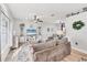 Cozy living room featuring a decorative fireplace, ceiling fan and ample natural light at 1500 Lemon Bay Dr, Venice, FL 34293