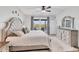 Bright main bedroom with a plush headboard, neutral tones and slider doors to the lanai at 1500 Lemon Bay Dr, Venice, FL 34293
