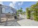 Enclosed patio with dining set, gravel landscaping, and lush tropical foliage creating a serene outdoor space at 1537 Overbrook Rd, Englewood, FL 34223