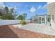 Spacious backyard with a screened-in pool area, white fence, and gravel ground cover at 1537 Overbrook Rd, Englewood, FL 34223